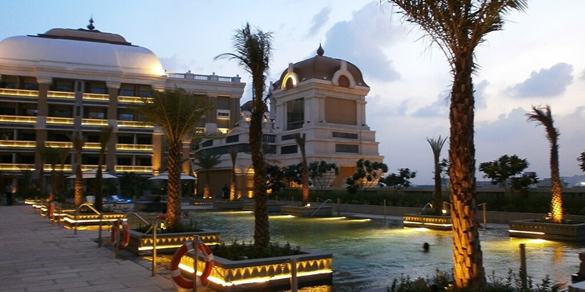 The grand exterior of ITC Grand Chola in Chennai, featuring impressive architectural details.