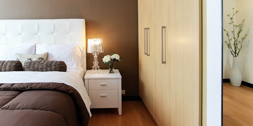 Spacious bedroom featuring a stylish closet and a neatly made bed for comfort