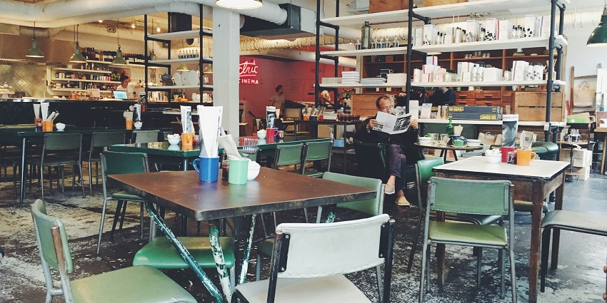 Elegant restaurant with glass doors, warm lighting, and a welcoming front desk area.