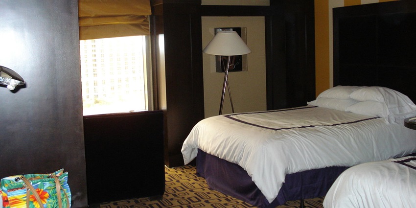 A vibrant hotel lounge with a stylish, modern interior. The room features cosy leather seating, a glass coffee table, and ambient lighting.