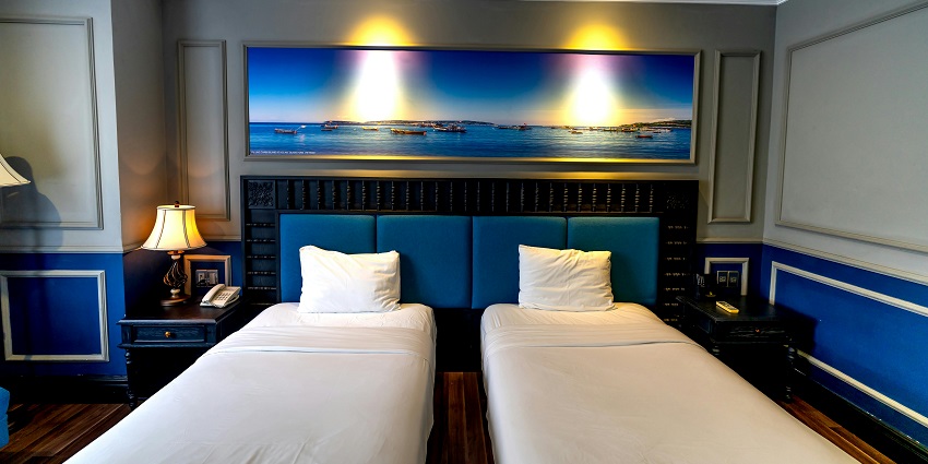 Stylish interior design of a hotel room featuring a large bed and a modern decor.