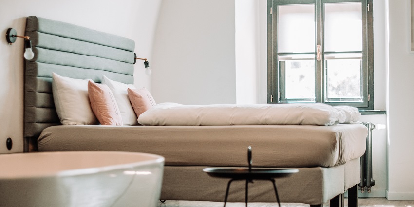 Stylish bedroom interior with modern design featuring a comfortable bed and decor.