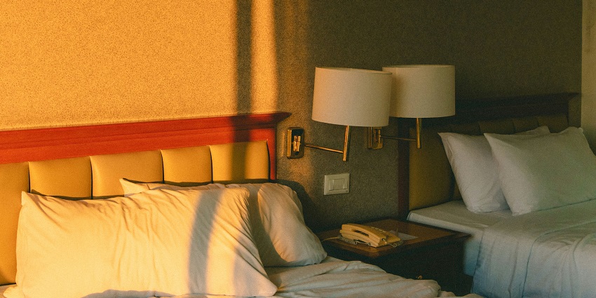 An affordable hotel room set in a serene outdoor environment with lush greenery.