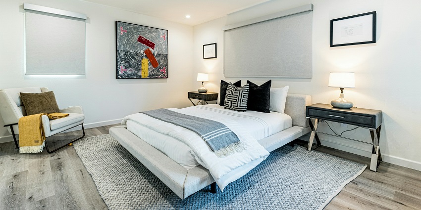 A photo of a bedroom featuring a white bed with soft linens near Samayapuram Temple.
