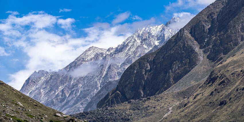 The view of the Himalayan mountain ranges from afar, surrounded by mist and snow.