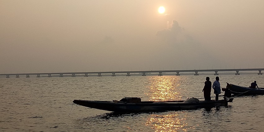 A scenic picture of two boats at Yanam Beach with gentle waves and golden sand.