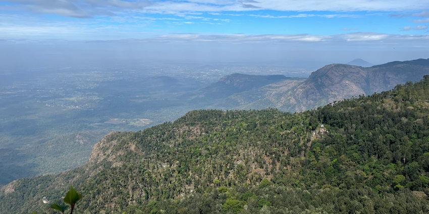 A bird’s eye view of Yercaud, featuring towering mountains and lush green vegetation.