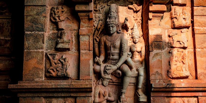 An inside view of the iconic Yoga Anjaneyar featuring carvings of God on the walls.