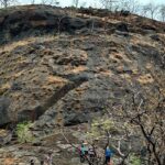 Mrugagad Fort, a tourist attraction near Maharashtra, stands atop rugged hills amid nature.