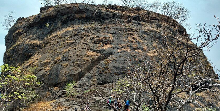 Mrugagad Fort, a tourist attraction near Maharashtra, stands atop rugged hills amid nature.