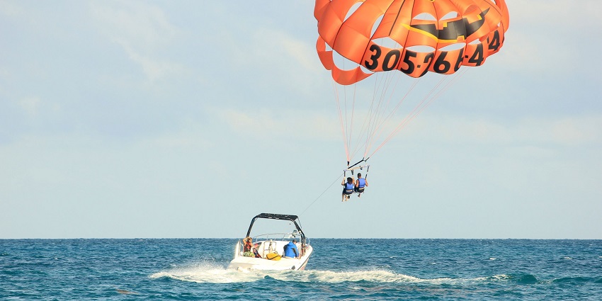 A breathtaking picture of parasailing over stunning coastal views