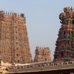 View of the temples of Madurai, India, with buildings and greenery surrounding them.