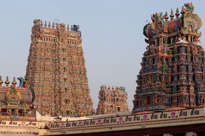 View of the temples of Madurai, India, with buildings and greenery surrounding them.