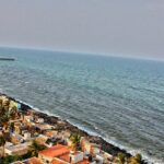 An aerial view of Pondicherry Rock Beach with waves crashing onto the rocky shore.