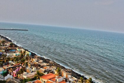 An aerial view of Pondicherry Rock Beach with waves crashing onto the rocky shore.