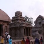 The outdoor area of the Ratha Temple, with a crowd of people seeking blessings.