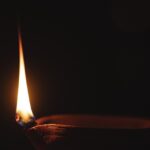 An image showing a diya lit up at a Sai Baba temple in Chennai.