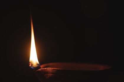 An image showing a diya lit up at a Sai Baba temple in Chennai.