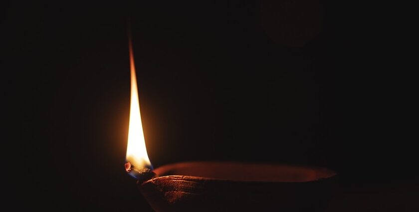 An image showing a diya lit up at a Sai Baba temple in Chennai.