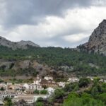 A scenic view of mountains in Malleswaram with a cluster of traditional houses.