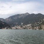 A picture of the beautiful Nainital Lake with a view of mountains in the background