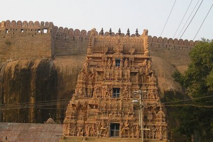 Thirumayam Temple complex, displaying the temple's vibrant gopuram with intricate carvings.