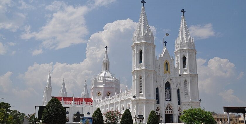 Front view of the Velankanni Temple with a tall Gothic architectural building and its area.