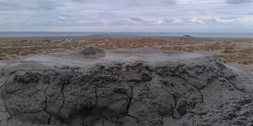 Coastal area featuring beaches, mud volcanoes, and cultural landmarks.