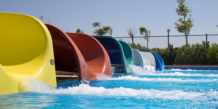 Bright water park slides under the sun with refreshing water splashes on a hot day.
