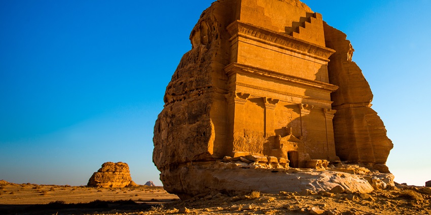 Ancient rock-cut tombs of Hegra in Al-Ula, surrounded by desert landscape–Places to visit in Saudi Arabia