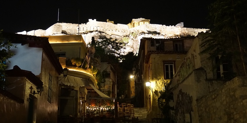 Anafiotika Street with old traditional houses, graffiti on walls and night lamps