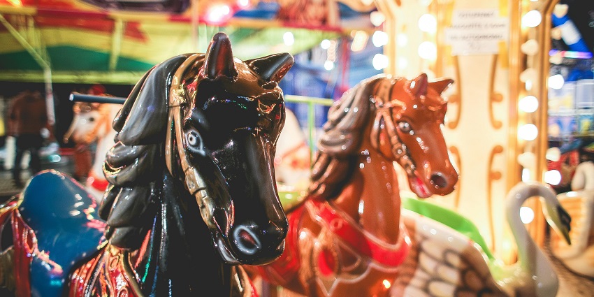 A close-up view of a brown and white carousel horse in NYC for children to enjoy.