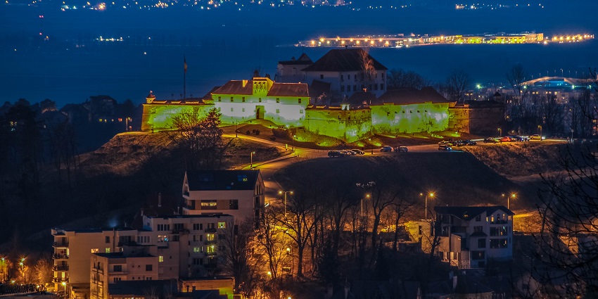 A glimpse of illuminated Brasov City at night to experience Romania nightlife.