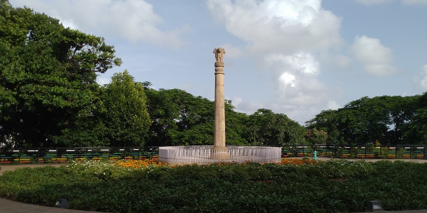 A view of the Ashoka Pillar, featuring four majestic lions and intricate carvings.