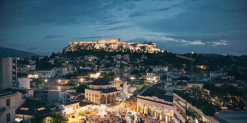 City of Athens at night with illuminated streets, buildings and bright Mount Acropolis
