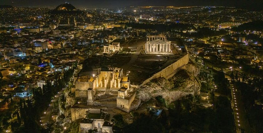 Acropolis with old ruined monuments surrounded by a vibrant and colourful city of Athens