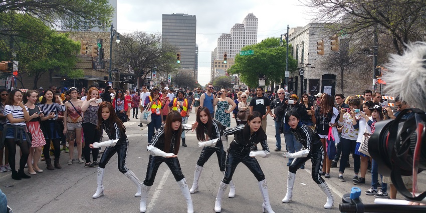 Korean artists perform a show on a road in Texas during the South by Southwest festival