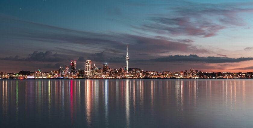 A view of the Vibrant streets of Auckland during night time and reflecting on the lake water