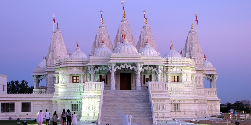 An image of BAPS Shri Swaminarayan Mandir showcasing intricate stone carvings and architecture.