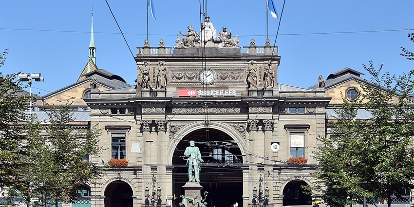 Luxury shopping street lined with boutiques, cafes, and landmarks at Bahnhofstrasse.