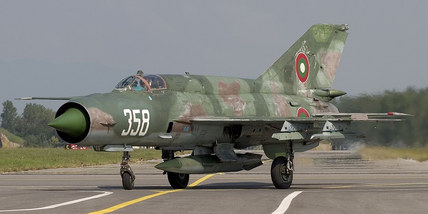 Bulgarian Air Force jet getting ready to take off from the airbase with greenery.
