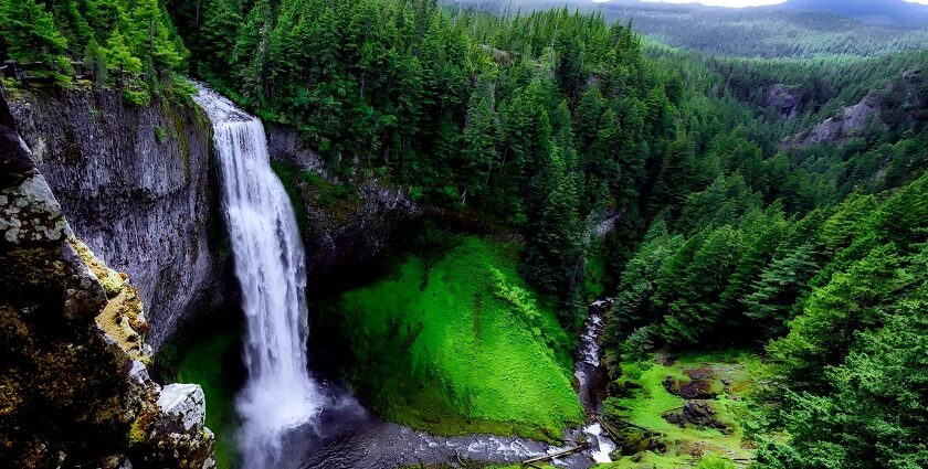 An Image of Scenic View of Bamni Waterfalls against the lush green forests and rolling hills.