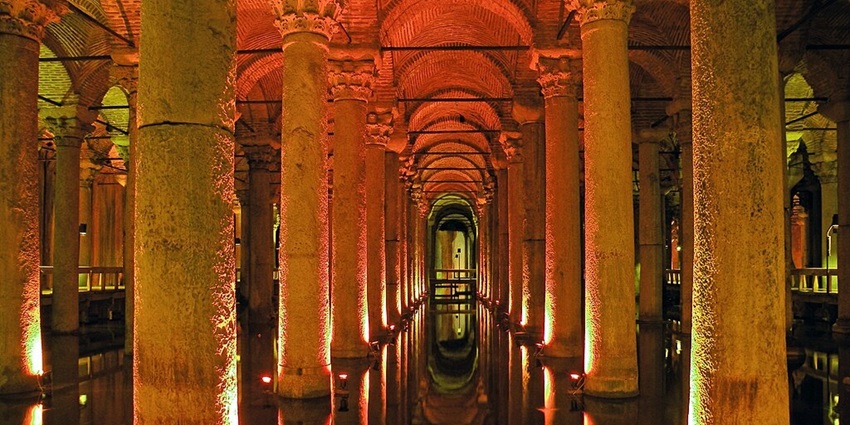Underground cistern featuring ancient columns and atmospheric lighting.