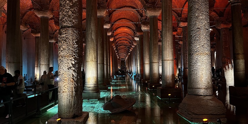 Underground ancient water reservoir featuring grand columns and a serene atmosphere.