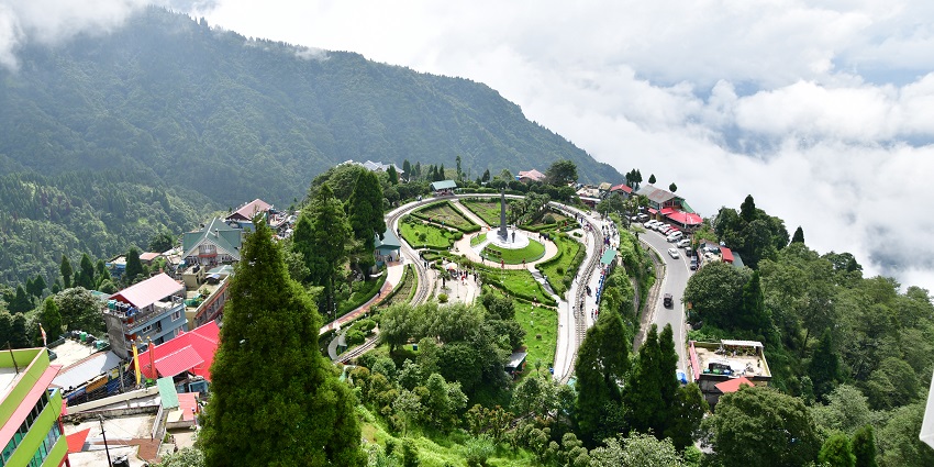 A picture of a garden view of Batasia Loop with the famous Darjeeling toy train.