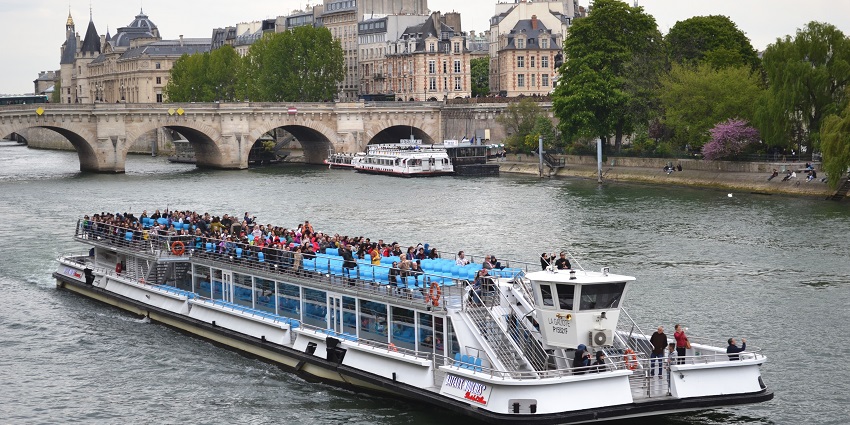 An image of a Parisian boat cruise offering scenic views of the city’s landmarks.