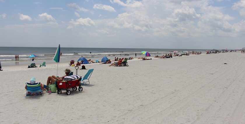 An image of beaches in Jacksonville Florida and distant buildings under a clear sky.