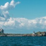 Beach in Boston with a lighthouse, offering scenic views of the shoreline and clear waters