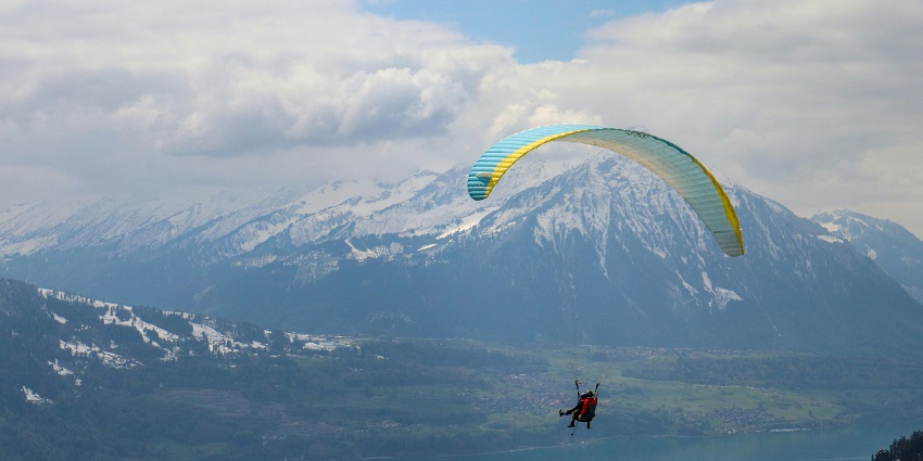 Paragliding in Interlaken with stunning views of Lake Thun and the Alps.
