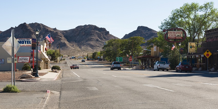 Quiet view of Main Street in Beatty, Nevada, featuring vintage buildings and mountain views